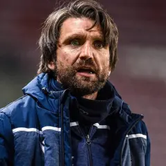 Peter Hyballa, Trainer, mit Bart und wachem Blick, trägt eine blaue Jacke.